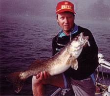 Mr. Wil Wegman holding a large walleye caught on Lake Simcoe.